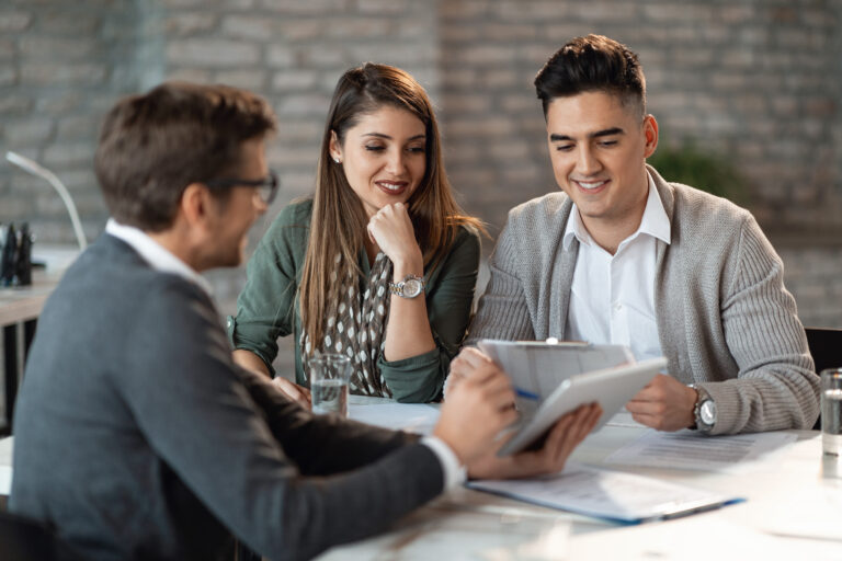 Happy couple going through their investment plans with financial advisor